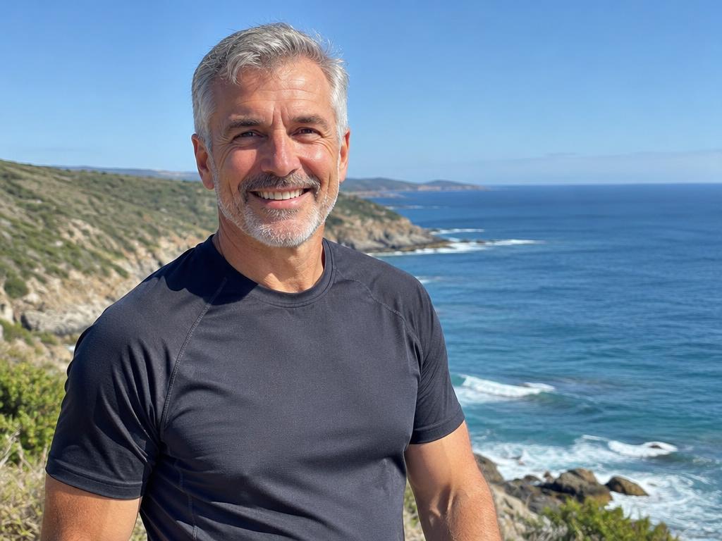 Grey-haired man beside the coast